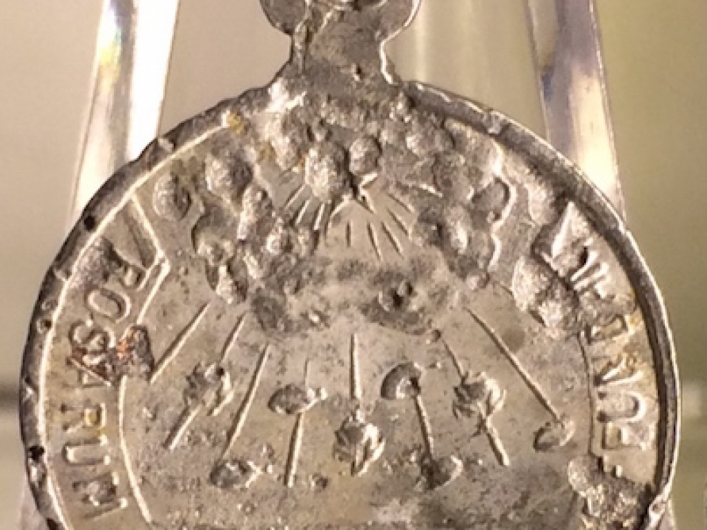 An aluminium Sanctify pendant (back)