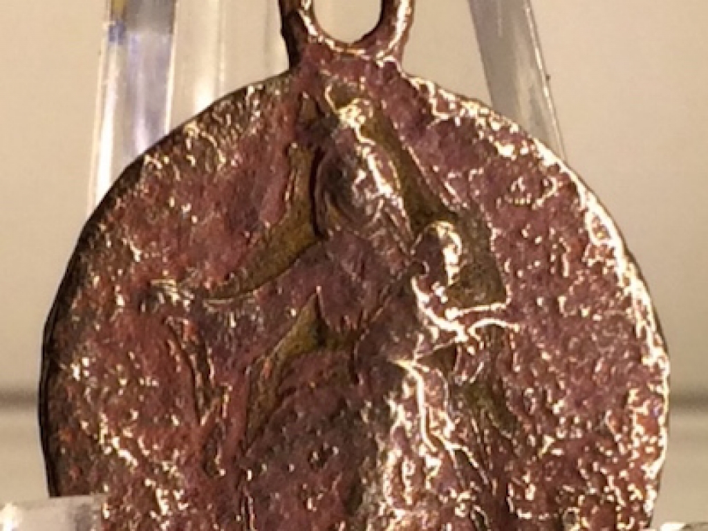 A silver Sanctify pendant - back