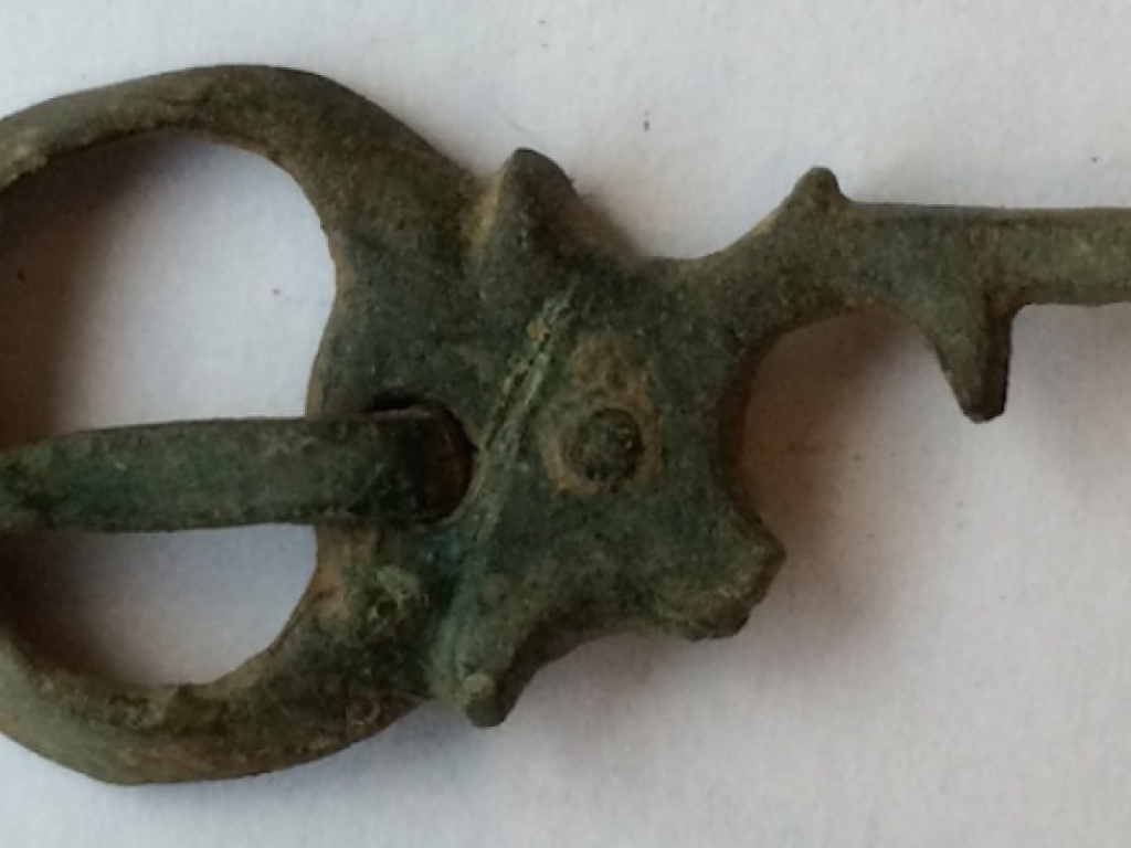 A piece of a Medieval buckle with an integrated buckle plate